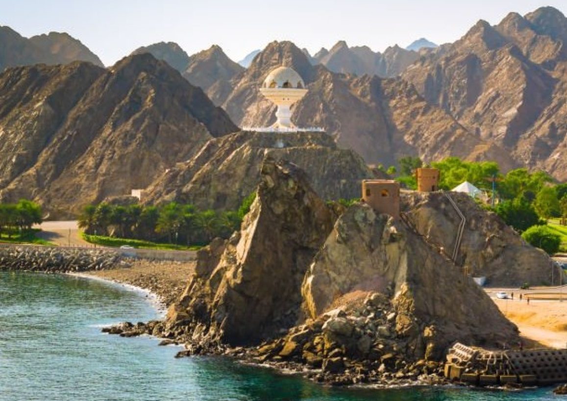 Mountain landscape of Muscat, Oman, Middle East. Scenic travel cruise destination with huge incense burner along the waterfront and harbor of Muscat.